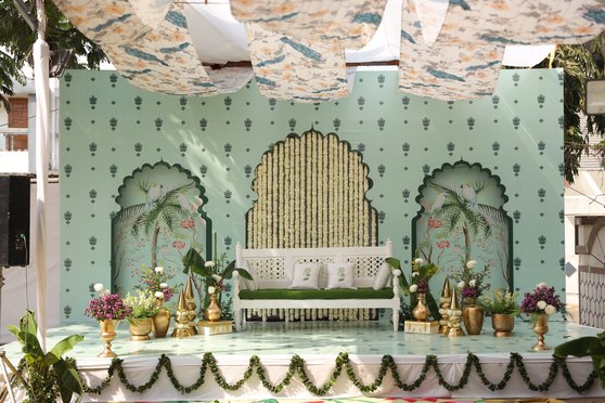 Mehendi stage with a pastel floral backdrop