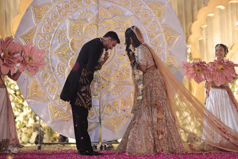 Bride and groom before a mandala backdrop